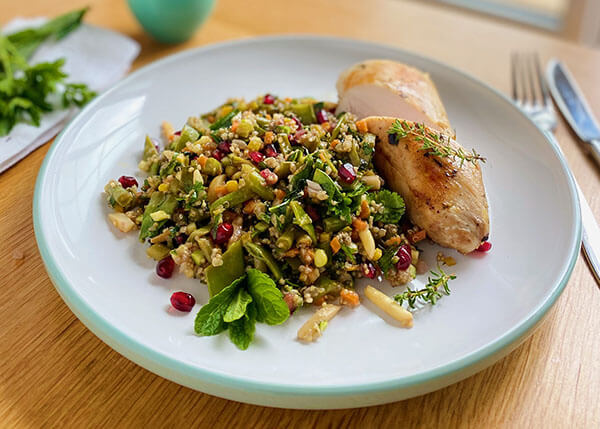 Crunchy vegetable and chicken salad with pomegranates and quinoa