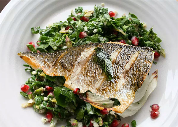 Dorade with summer salad of spinach, fennel, pomegranate, walnuts and feta cheese