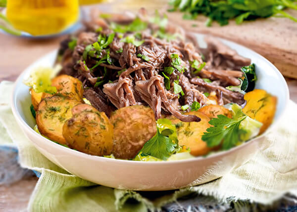 Pulled beef cheeks with braised cabbage and baby potatoes