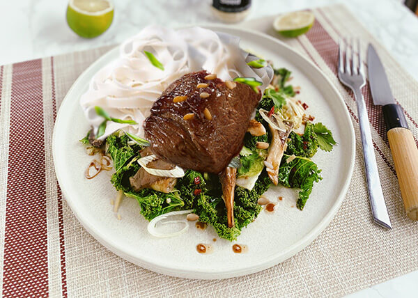 Korean-style fillet of veal, pan-fried kale, oyster mushrooms an rice noodles