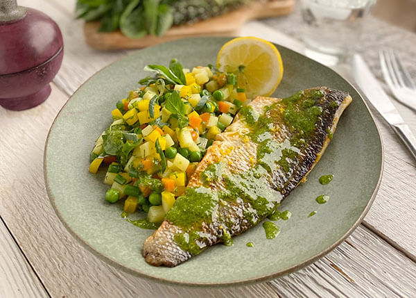 Grilled sea bass fillet with peas, carrots, green beans and potatoes