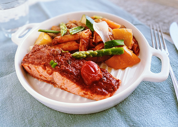 Salmon puttanesca style, penne and spring vegetables
