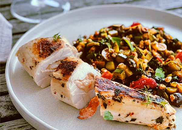 Chicken supreme stuffed with goat cheese and apricots vegetables with capers