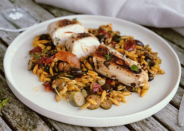 Chicken supreme stuffed with goat cheese and apricots, vegetables with capers and little orzo pasta
