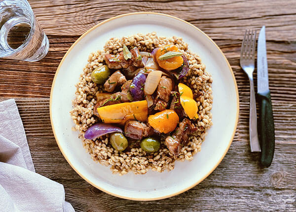 Sauté of pork with apricots, peppers and olives, pearl barley